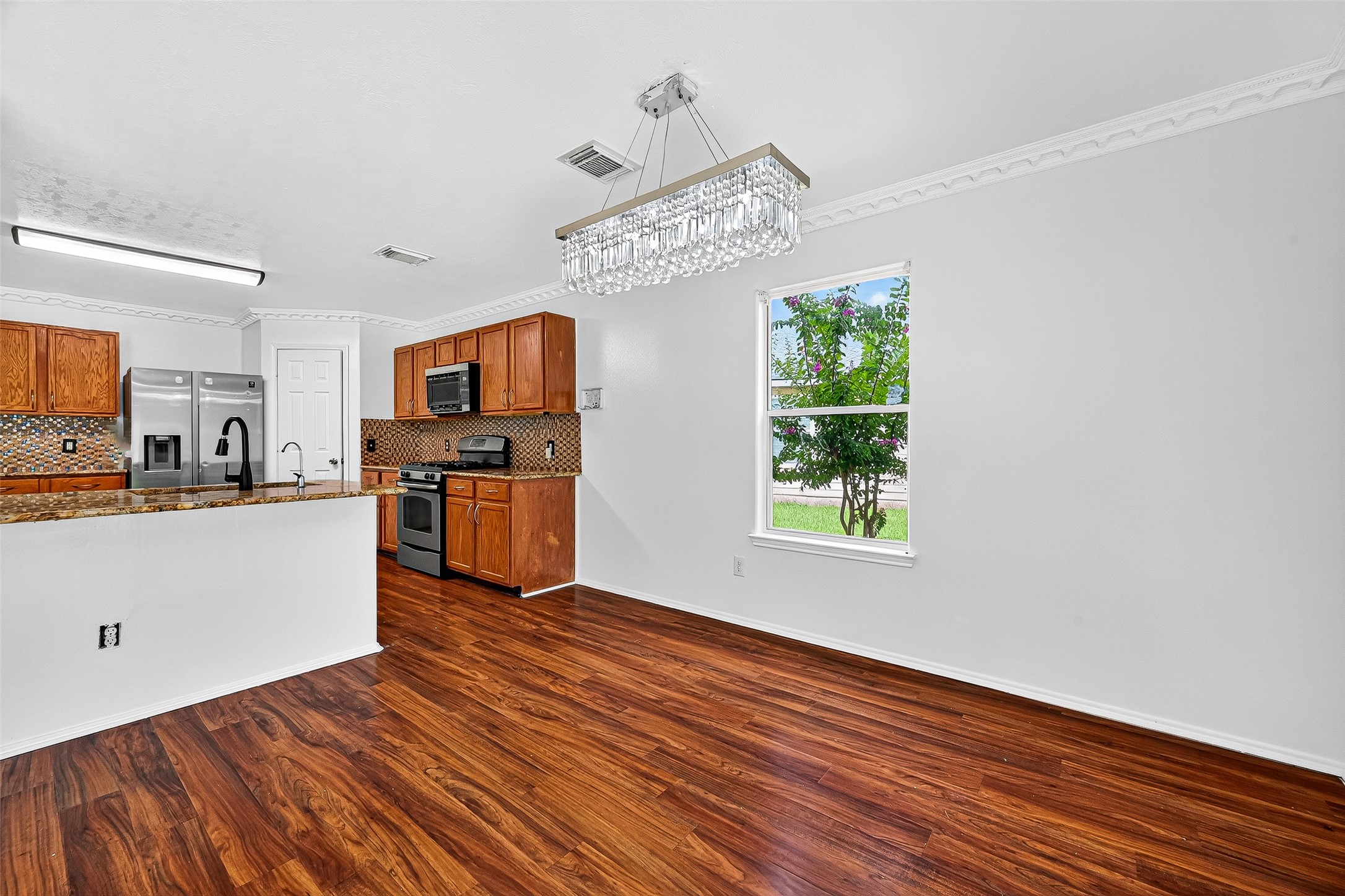634 Hawthorne Pasture Road Rosenberg, TX 77471 - Photo 14 of 49 a view of kitchen with wooden floor electronic appliances and window