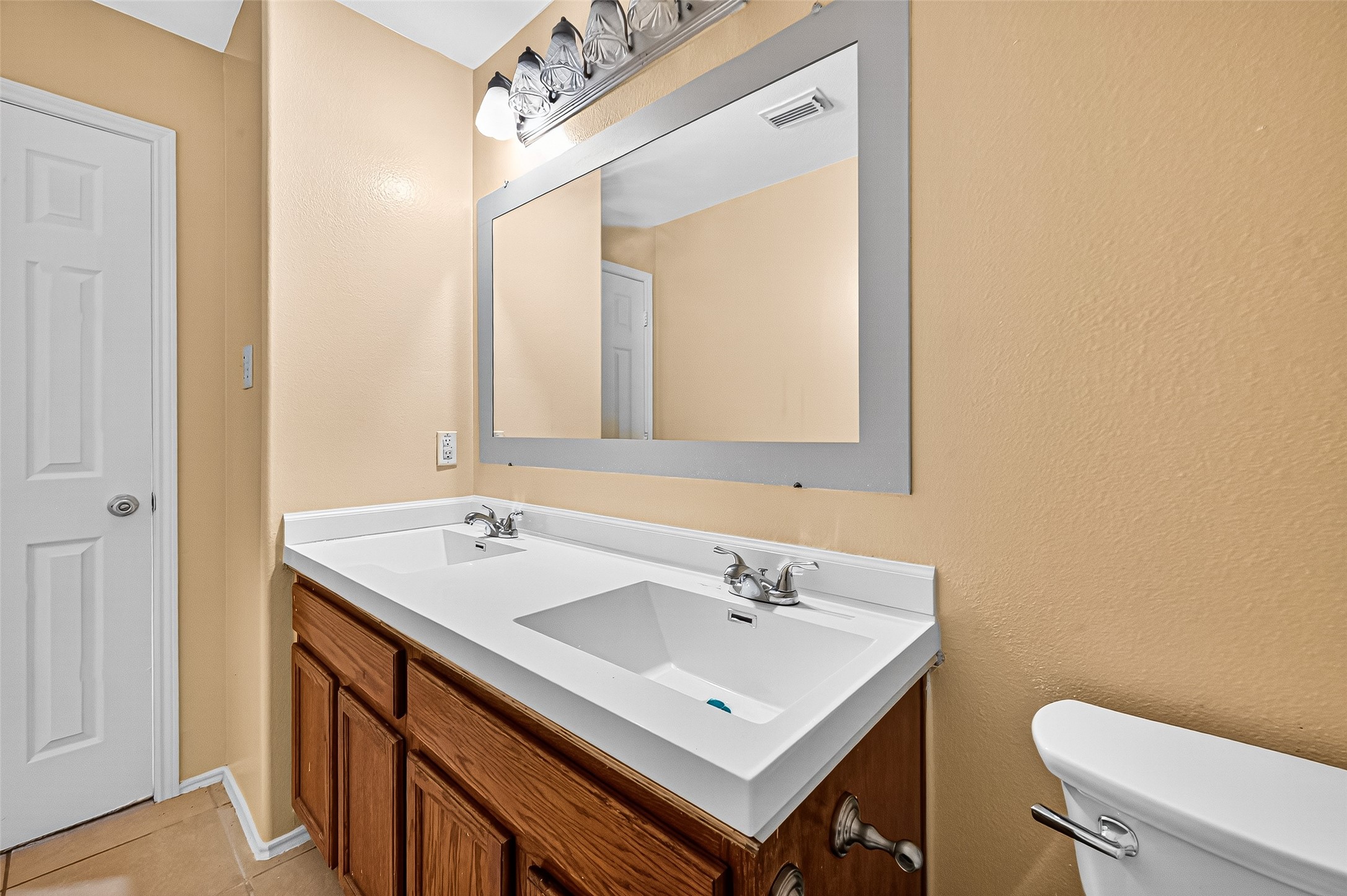 634 Hawthorne Pasture Road Rosenberg, TX 77471 - Photo 29 of 49 a bathroom with a sink vanity mirror and toilet