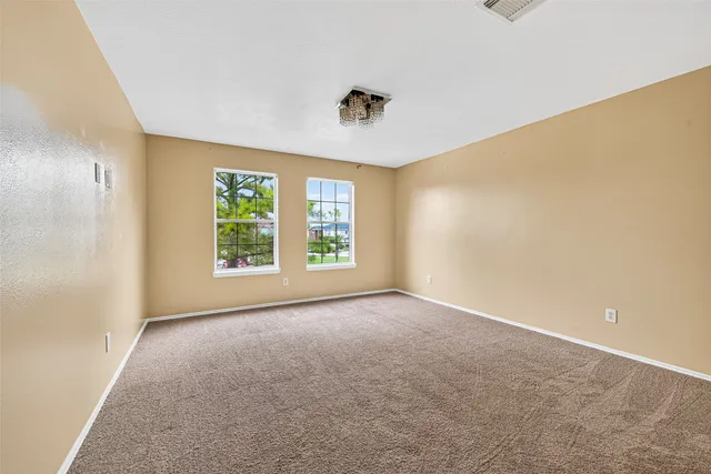 a view of a livingroom with a ceiling fan and window