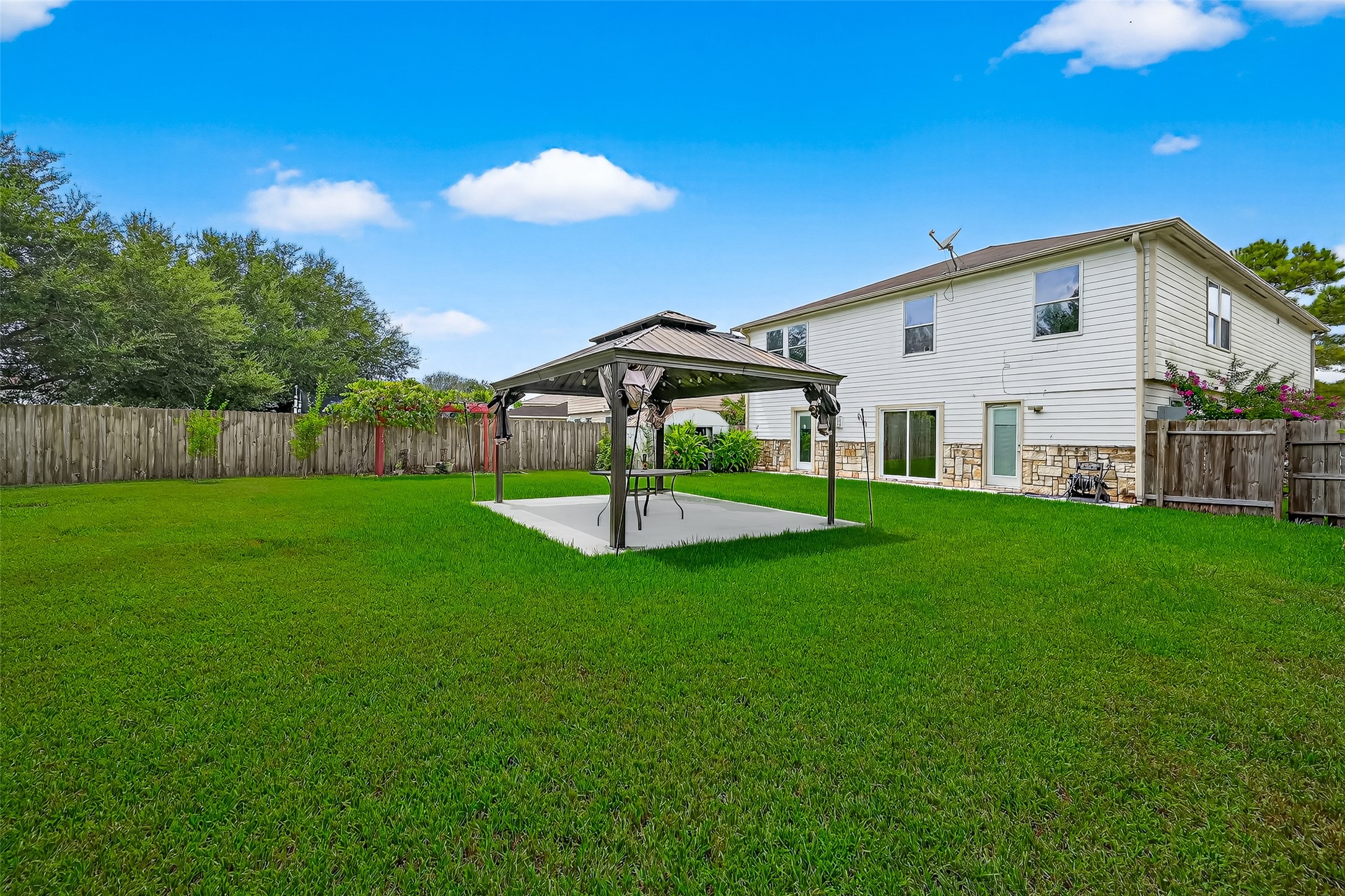 634 Hawthorne Pasture Road Rosenberg, TX 77471 - Photo 48 of 49 a view of a house with backyard and a tree