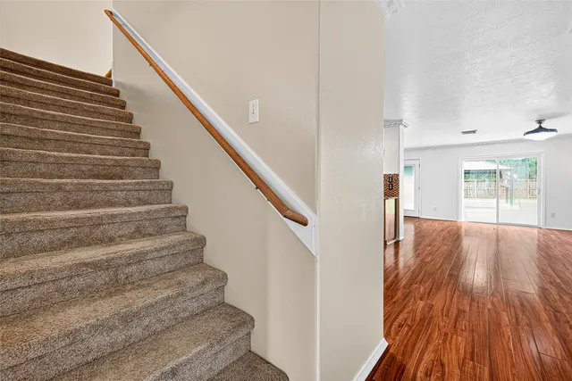 a view of entryway and hall with wooden floor