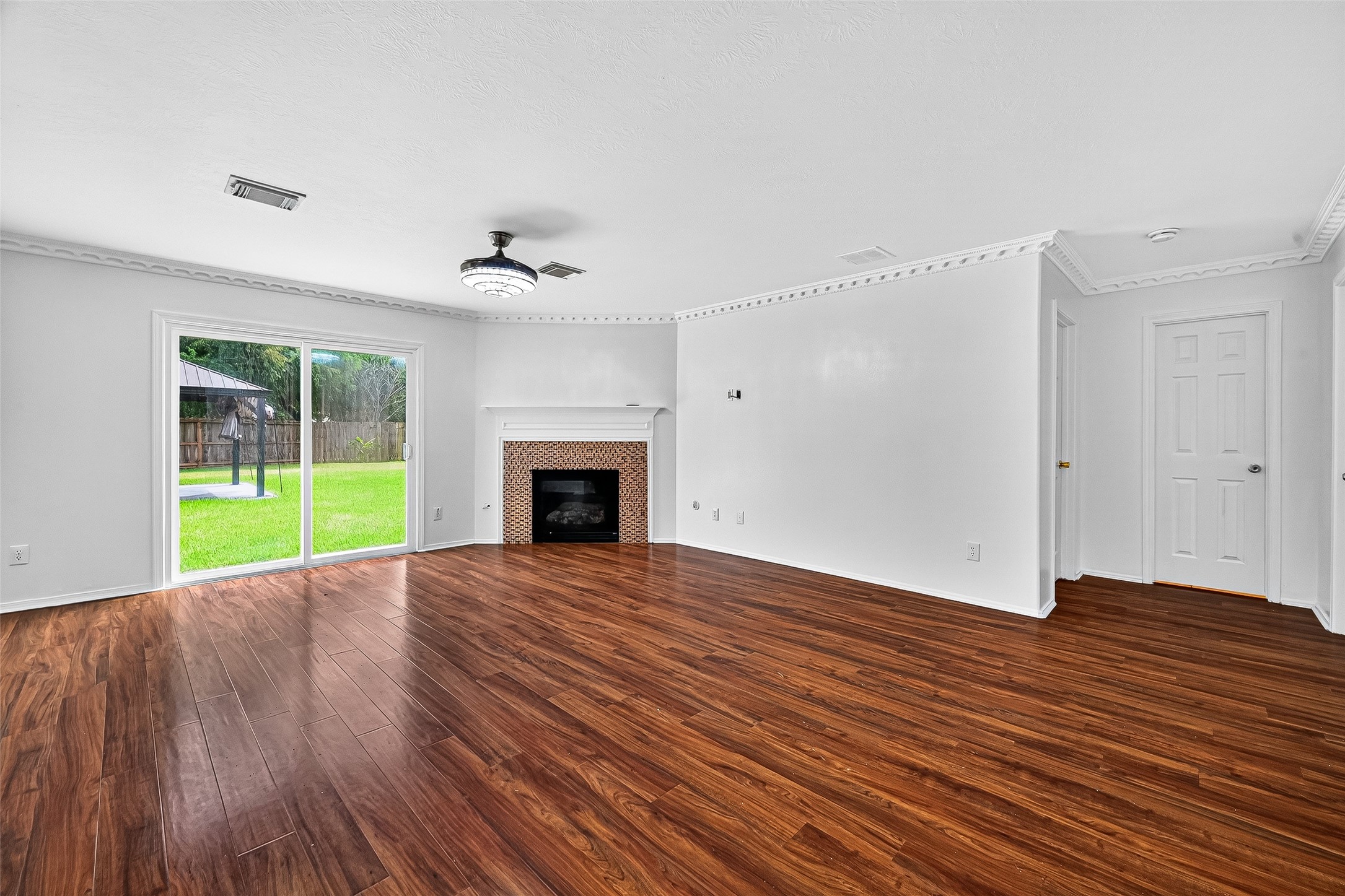 634 Hawthorne Pasture Road Rosenberg, TX 77471 - Photo 10 of 49 a view of an empty room with a fireplace and a window
