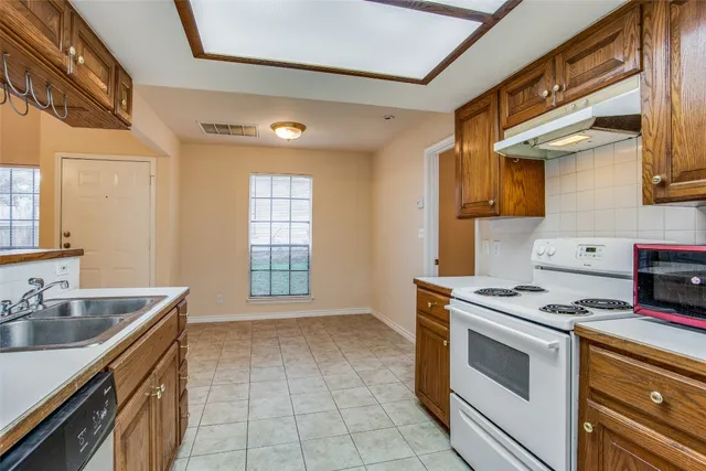 a kitchen with a stove and a sink