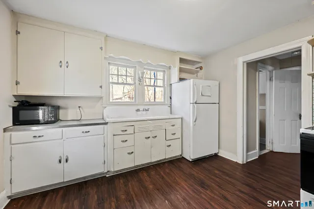 a view of a kitchen with stainless steel appliances granite countertop a stove and a refrigerator