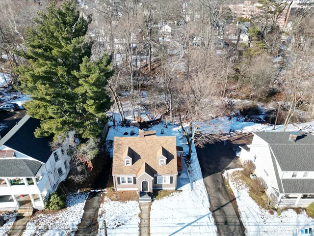 an aerial view of a house with a yard