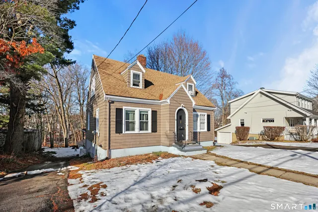 a view of a house with a snow in the yard