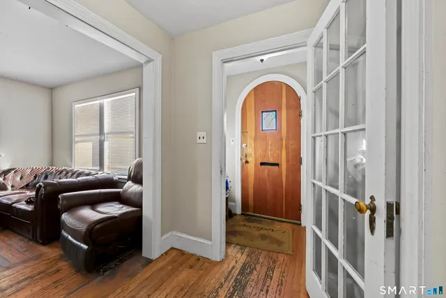 a living room with furniture and a wooden floor