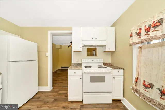a white refrigerator freezer sitting inside of a kitchen