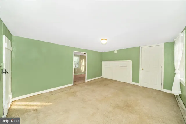 a view of a livingroom with wooden floor and a window