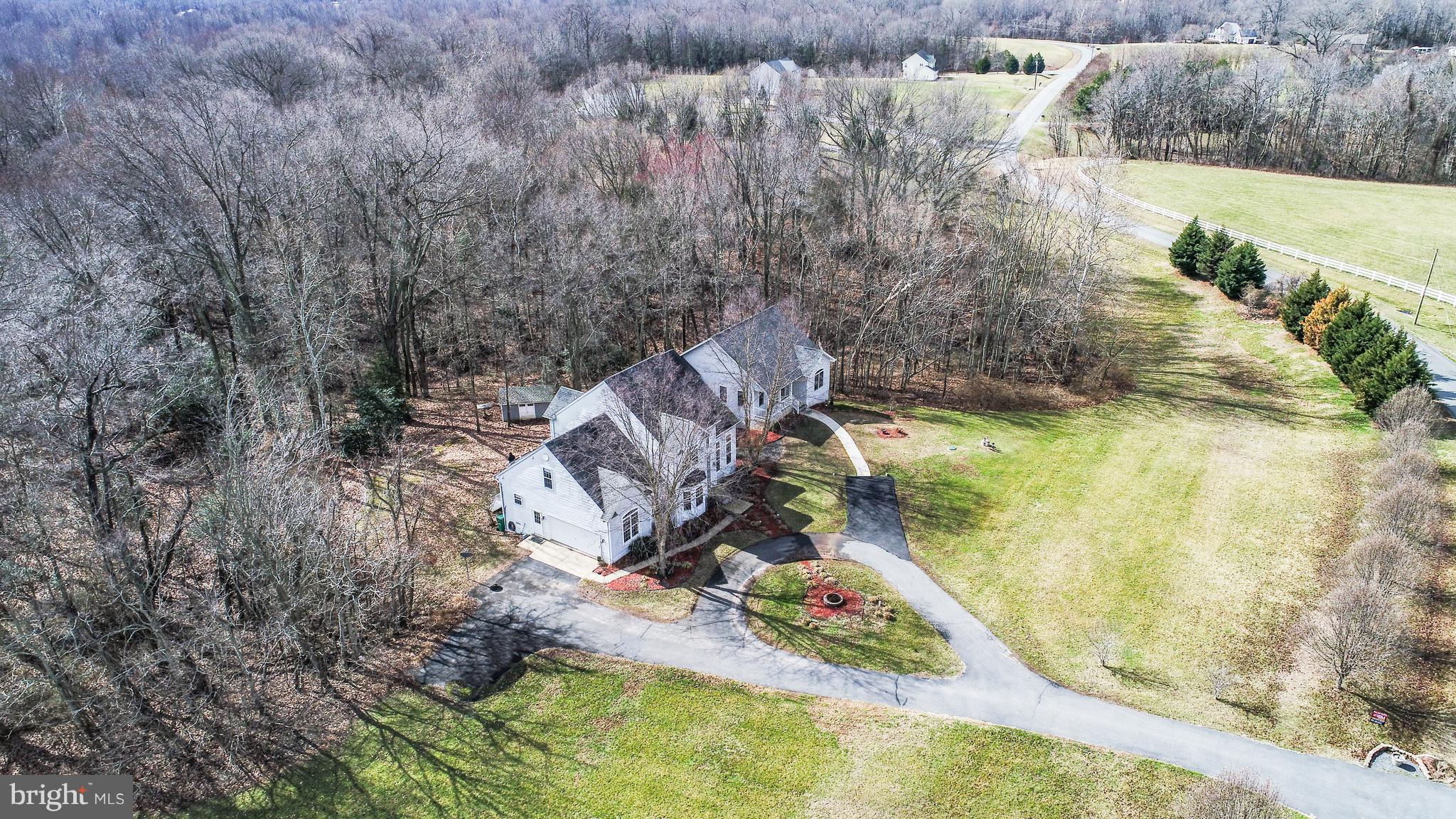 Aerial View of home. Wooded in the rear.