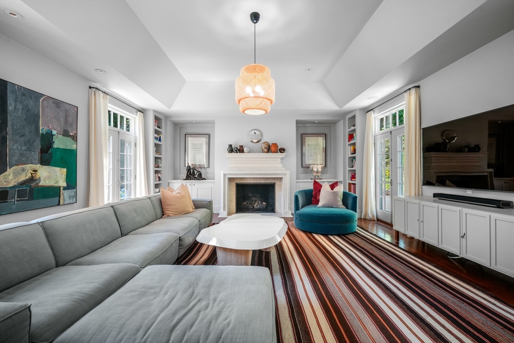 100 Chestnut Street Weston, MA 02493 - Photo 11 of 17 a living room with furniture a flat screen tv and a fireplace