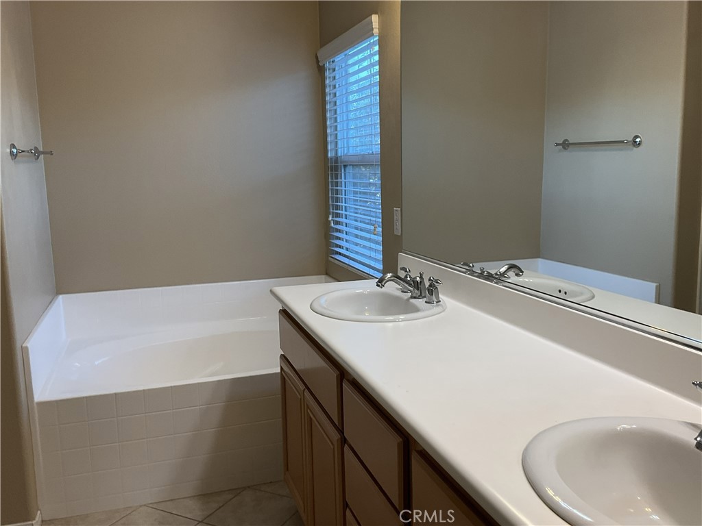 4574 Sandano Street Riverside, CA 92507 - Photo 11 of 12 a bathroom with a sink and a bathtub