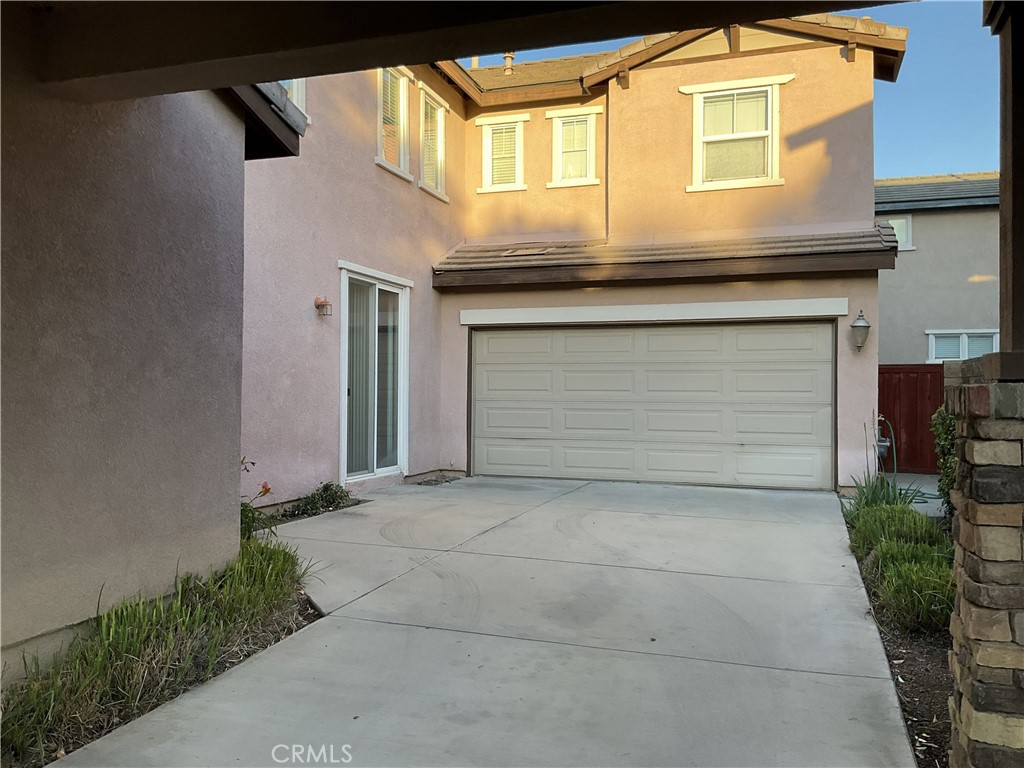 4574 Sandano Street Riverside, CA 92507 - Photo 2 of 12 a front view of a house with garage