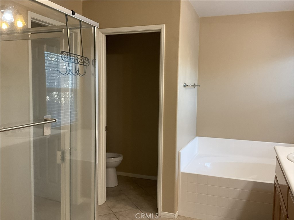 4574 Sandano Street Riverside, CA 92507 - Photo 10 of 12 a bathroom with a shower and a toilet