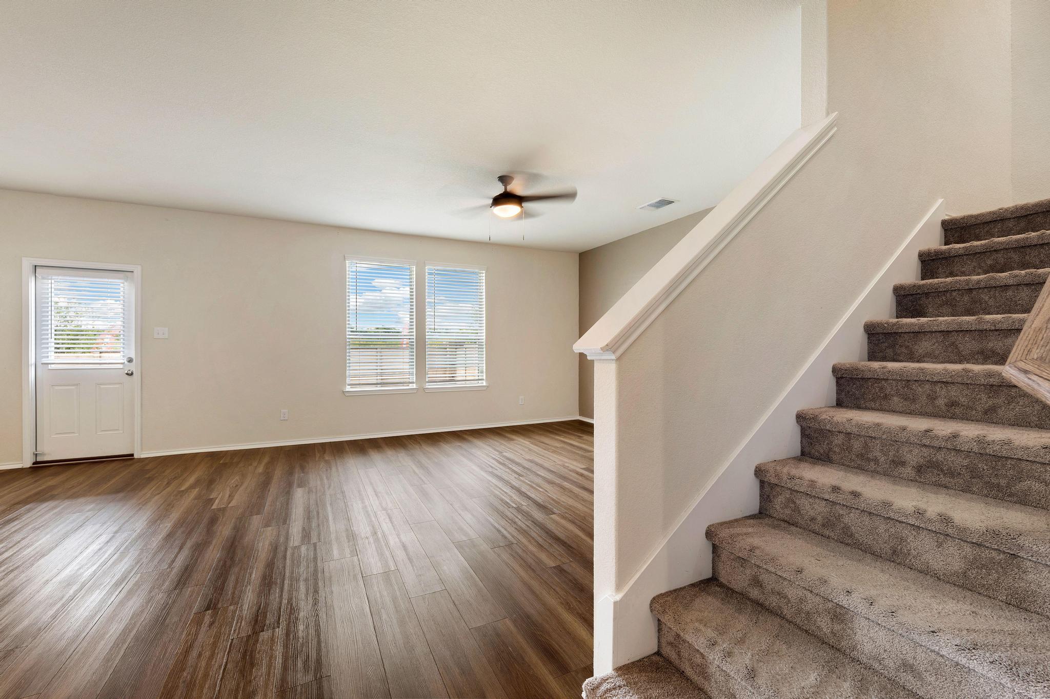 217 Innisfree Road Jarrell, TX 76537 - Photo 8 of 39 A well-lit living area features warm wood type flooring