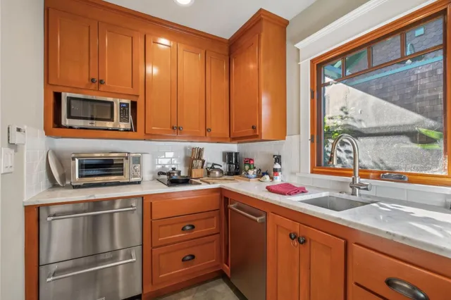a kitchen with stainless steel appliances granite countertop cabinets and a sink