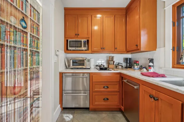 a kitchen with stainless steel appliances granite countertop a sink and cabinets
