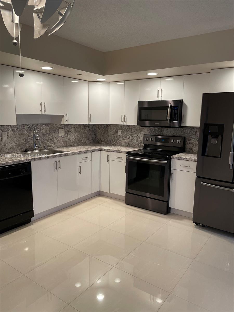 Horizons West Miami, FL 33183 - Photo 1 of 9 a kitchen with stainless steel appliances granite countertop a stove top oven a sink and a microwave