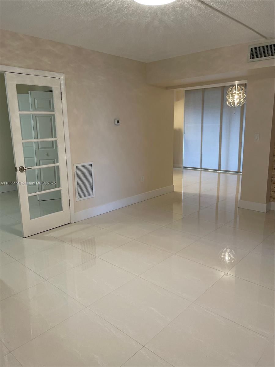 Horizons West Miami, FL 33183 - Photo 2 of 9 an empty room with a cabinet and mirrors