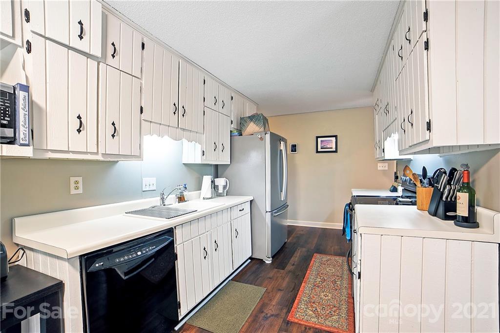 2 Arnstein Circle Fletcher, NC 28732 - Photo 9 of 29 a kitchen with white cabinets sink and white appliances