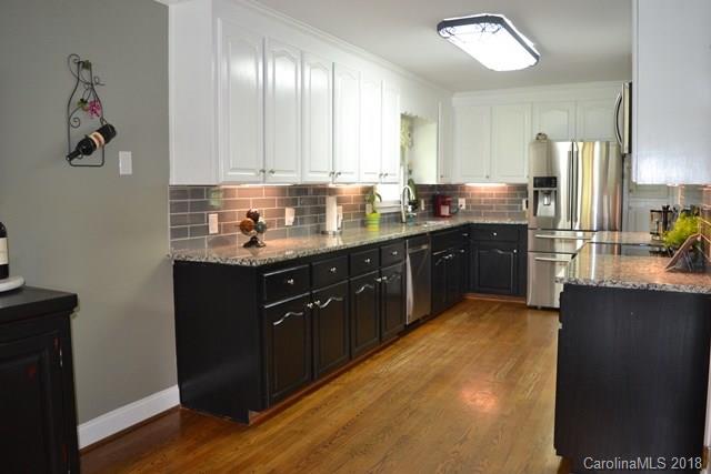 309 Parker Road York, SC 29745 - Photo 8 of 25 a kitchen with stainless steel appliances granite countertop a sink stove and refrigerator
