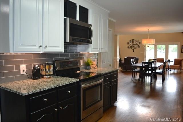 309 Parker Road York, SC 29745 - Photo 9 of 25 a kitchen with granite countertop stainless steel appliances and wooden cabinets