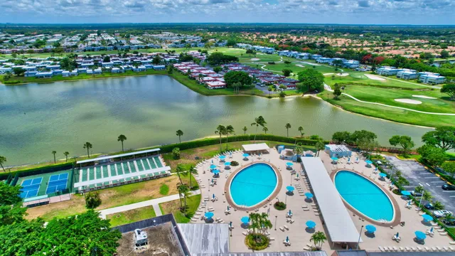 an aerial view of a house with swimming pool and outdoor seating