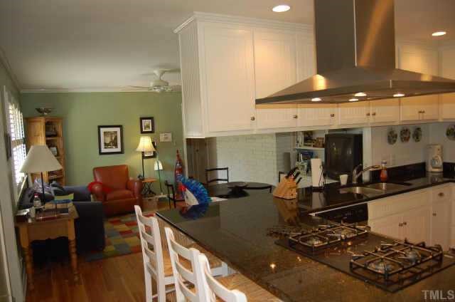 3213 Oak Grove Circle Raleigh, NC 27607 - Photo 2 of 10 a kitchen with stainless steel appliances granite countertop a sink stove and cabinets