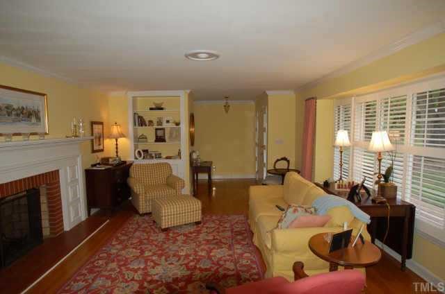 3213 Oak Grove Circle Raleigh, NC 27607 - Photo 5 of 10 a living room with furniture rug and fireplace