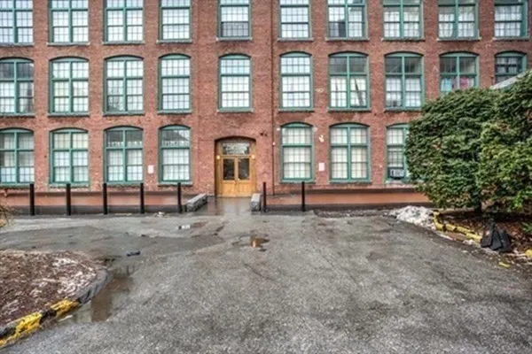 a front view of a building with a yard