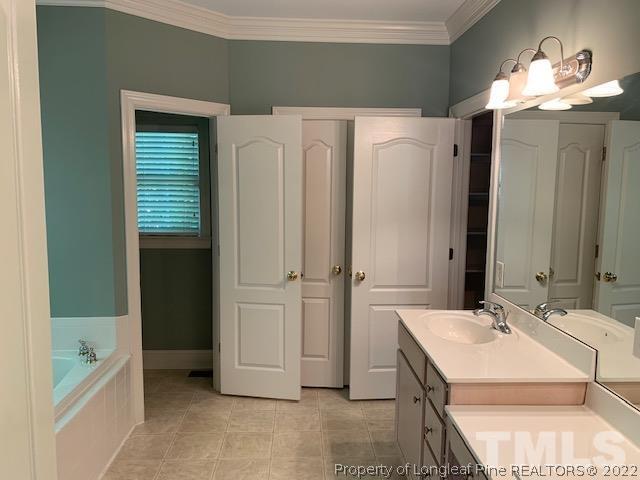 418 Summers Walk Circle Garner, NC 27529 - Photo 13 of 17 a bathroom with a sink a mirror and a shower