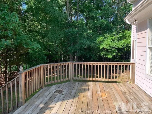 a view of deck with wooden floor and fence