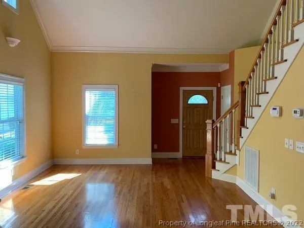 a view of an entryway with wooden floor and windows