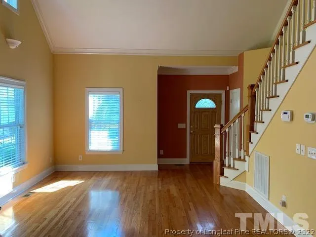 a view of an entryway with wooden floor and windows