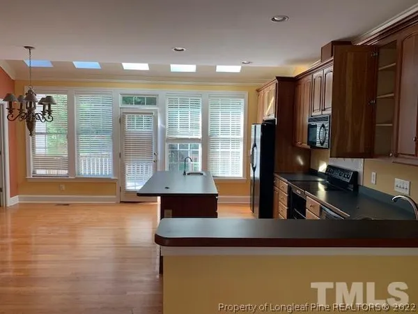 a kitchen with stainless steel appliances granite countertop a refrigerator and a stove