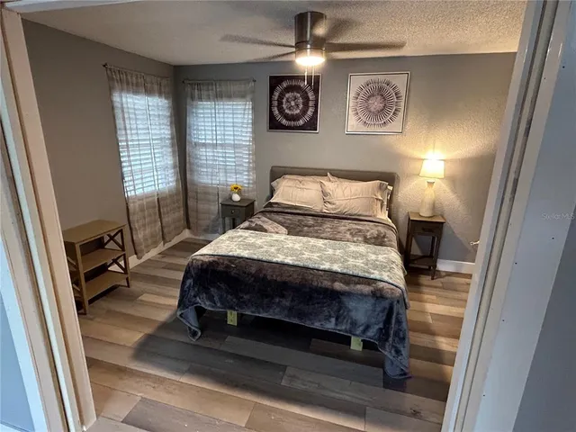 a bed sitting in a bedroom next to a window