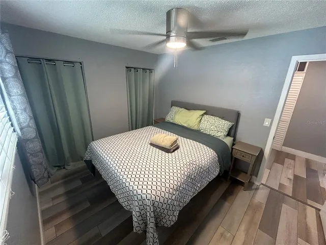 a bedroom with a bed and a mirror
