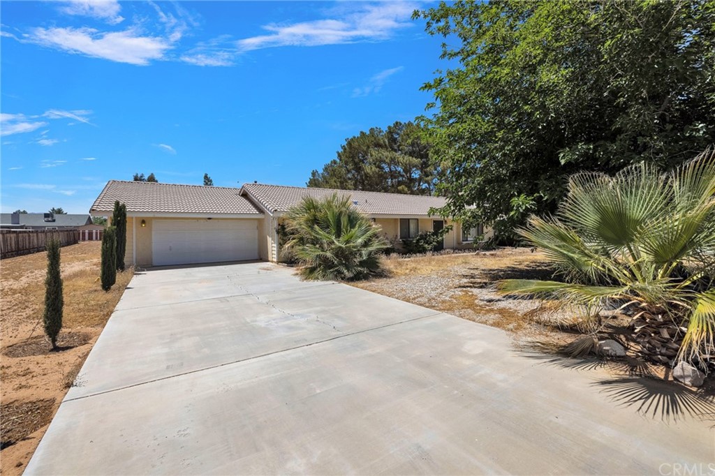 22193 Cholena Road Apple Valley, CA 92307 - Photo 1 of 1 a wooden bench sitting in front of a building