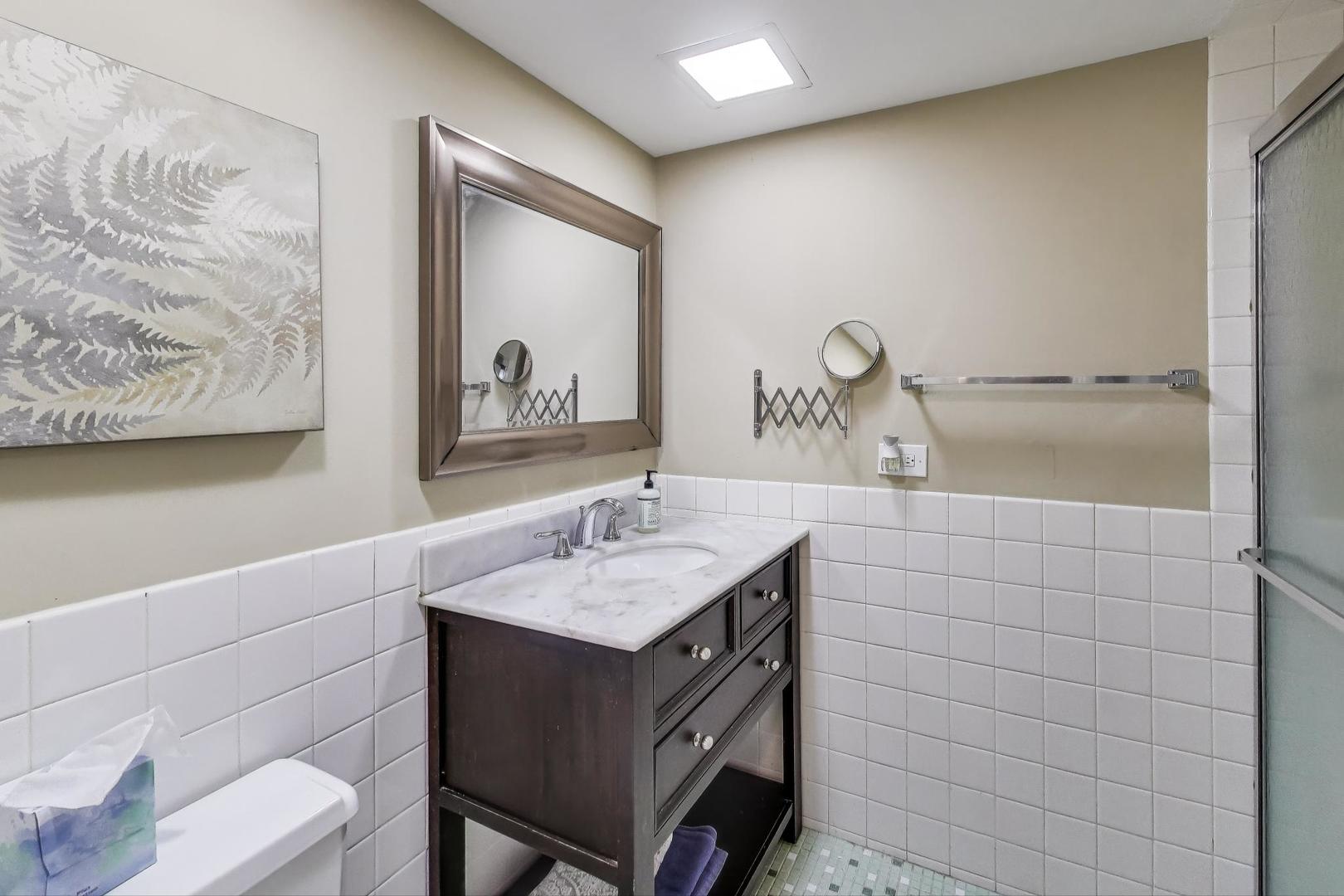 1847 Tanglewood Drive, Unit 2B Glenview, IL 60025 - Photo 13 of 26 a bathroom with a sink and a mirror