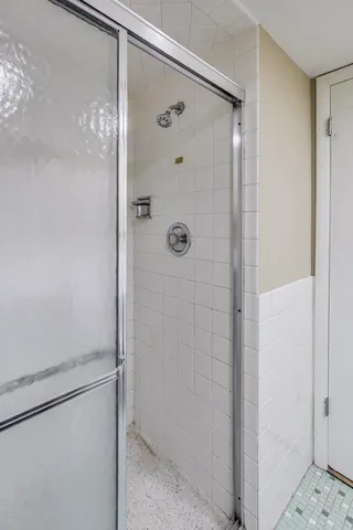 a bathroom with a glass shower door