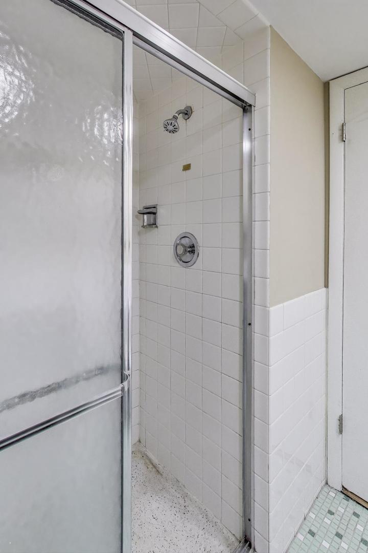 1847 Tanglewood Drive, Unit 2B Glenview, IL 60025 - Photo 14 of 26 a bathroom with a glass shower door