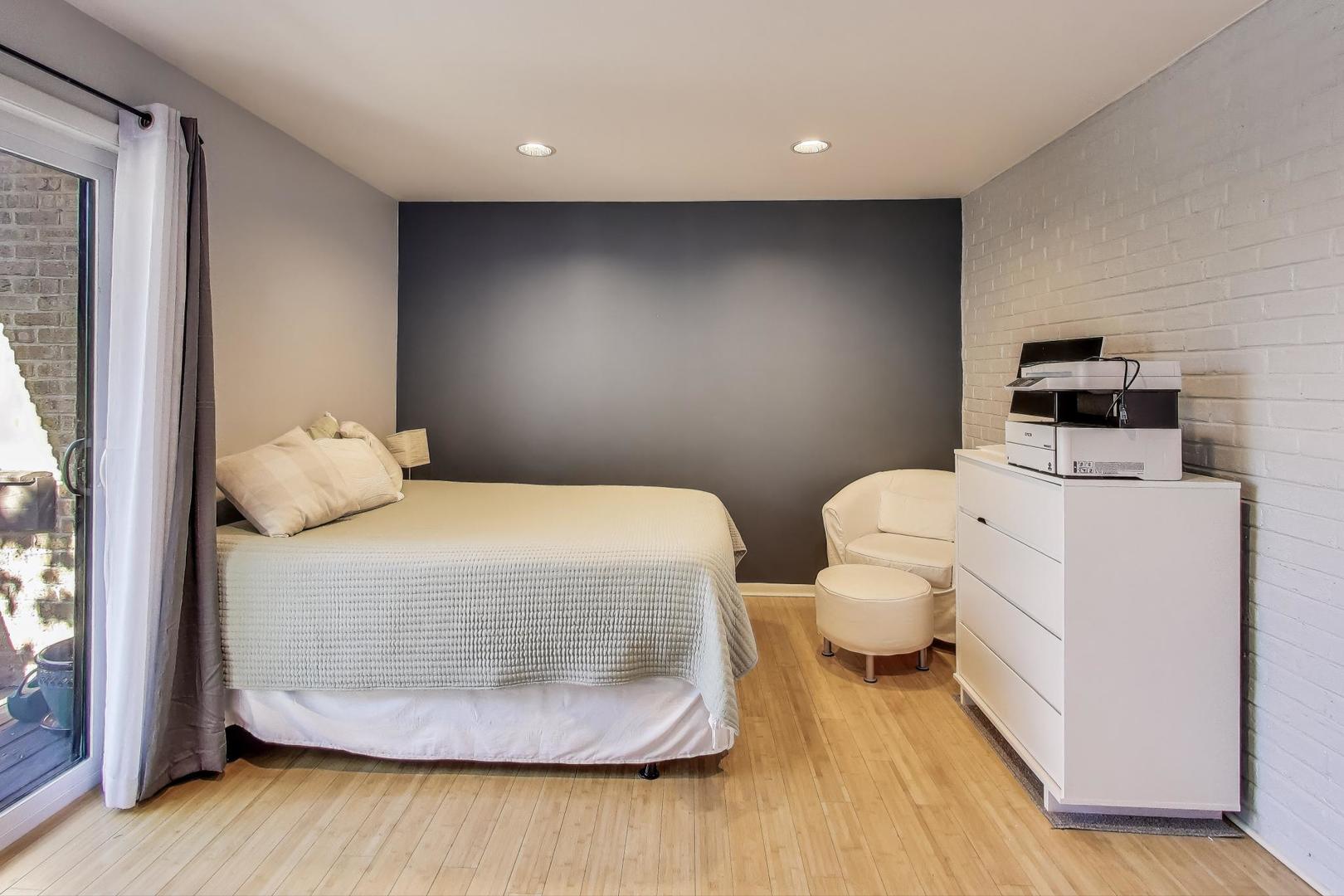 1847 Tanglewood Drive, Unit 2B Glenview, IL 60025 - Photo 15 of 26 a bedroom with a bed and wooden floor