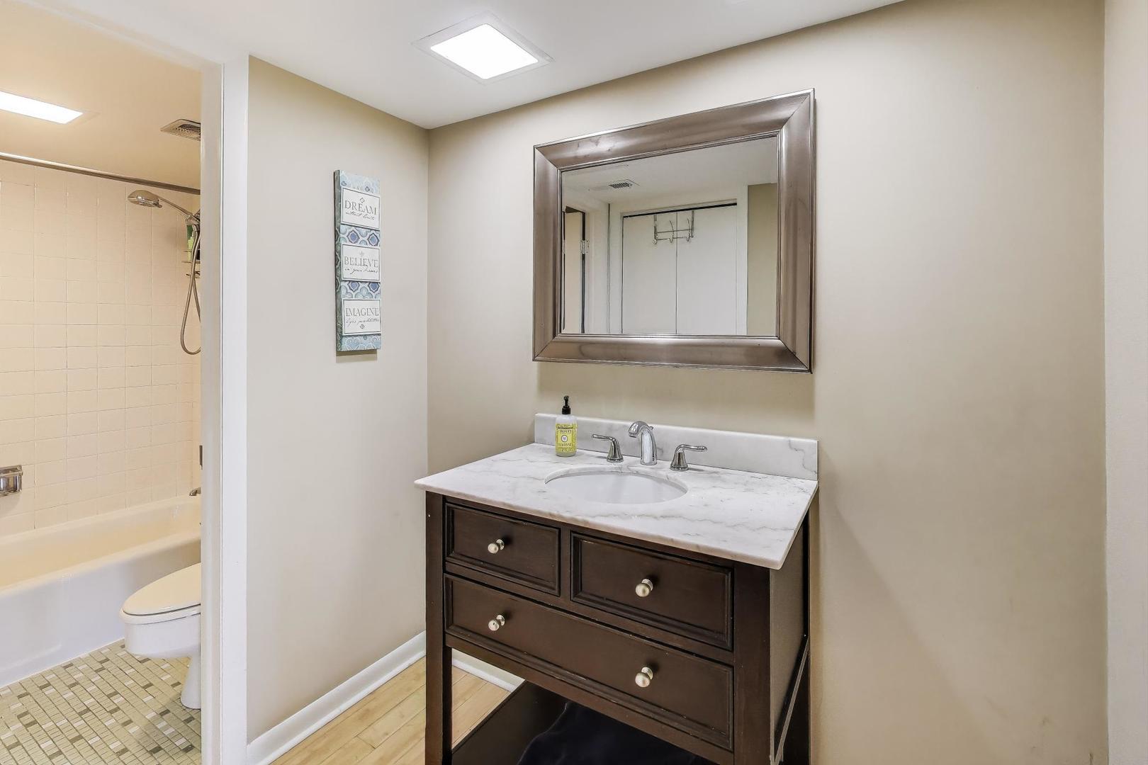 1847 Tanglewood Drive, Unit 2B Glenview, IL 60025 - Photo 17 of 26 a bathroom with a sink and a mirror
