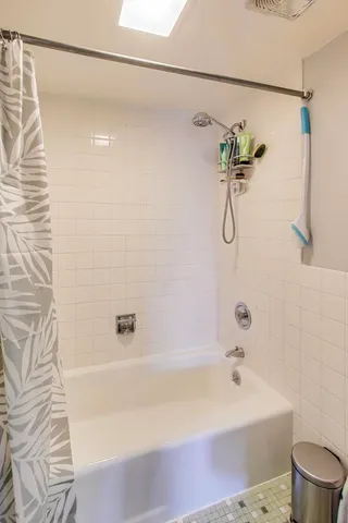 a bathroom with a bathtub and a shower