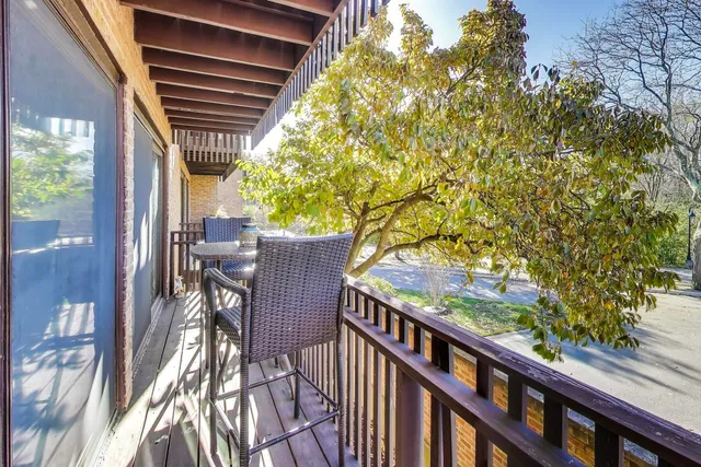 a view of balcony with wooden floor and outdoor seating