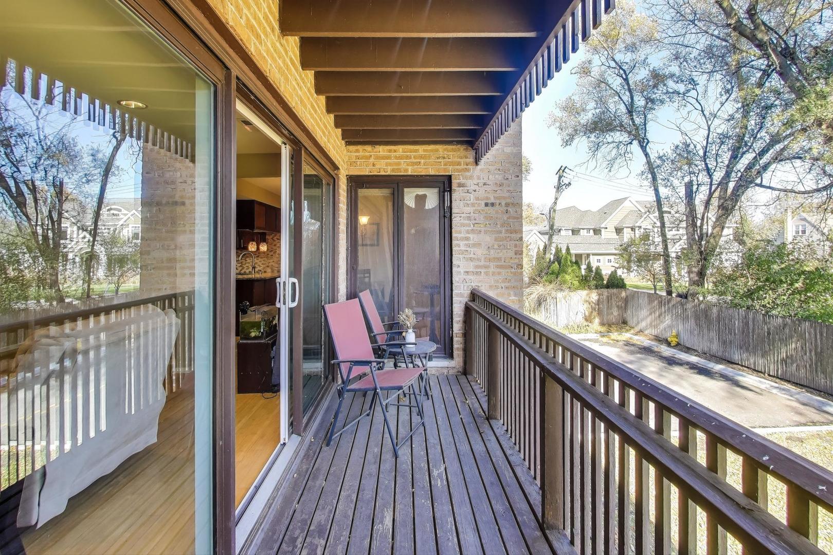 1847 Tanglewood Drive, Unit 2B Glenview, IL 60025 - Photo 21 of 26 a view of balcony with furniture and wooden floor
