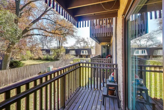 a view of a balcony with wooden floor