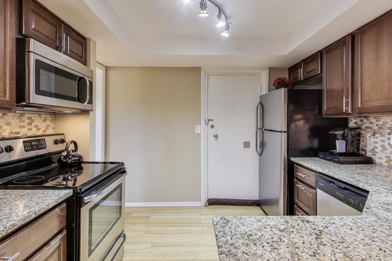 1847 Tanglewood Drive, Unit 2B Glenview, IL 60025 - Photo 3 of 26 a kitchen with a stove and a microwave