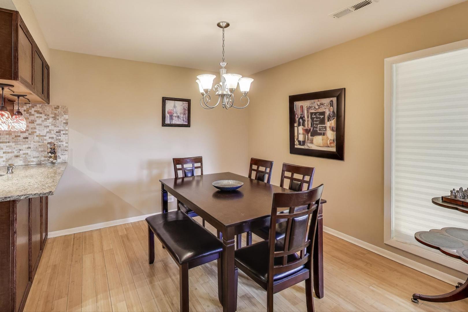 1847 Tanglewood Drive, Unit 2B Glenview, IL 60025 - Photo 7 of 26 a view of a dining room with furniture and wooden floor