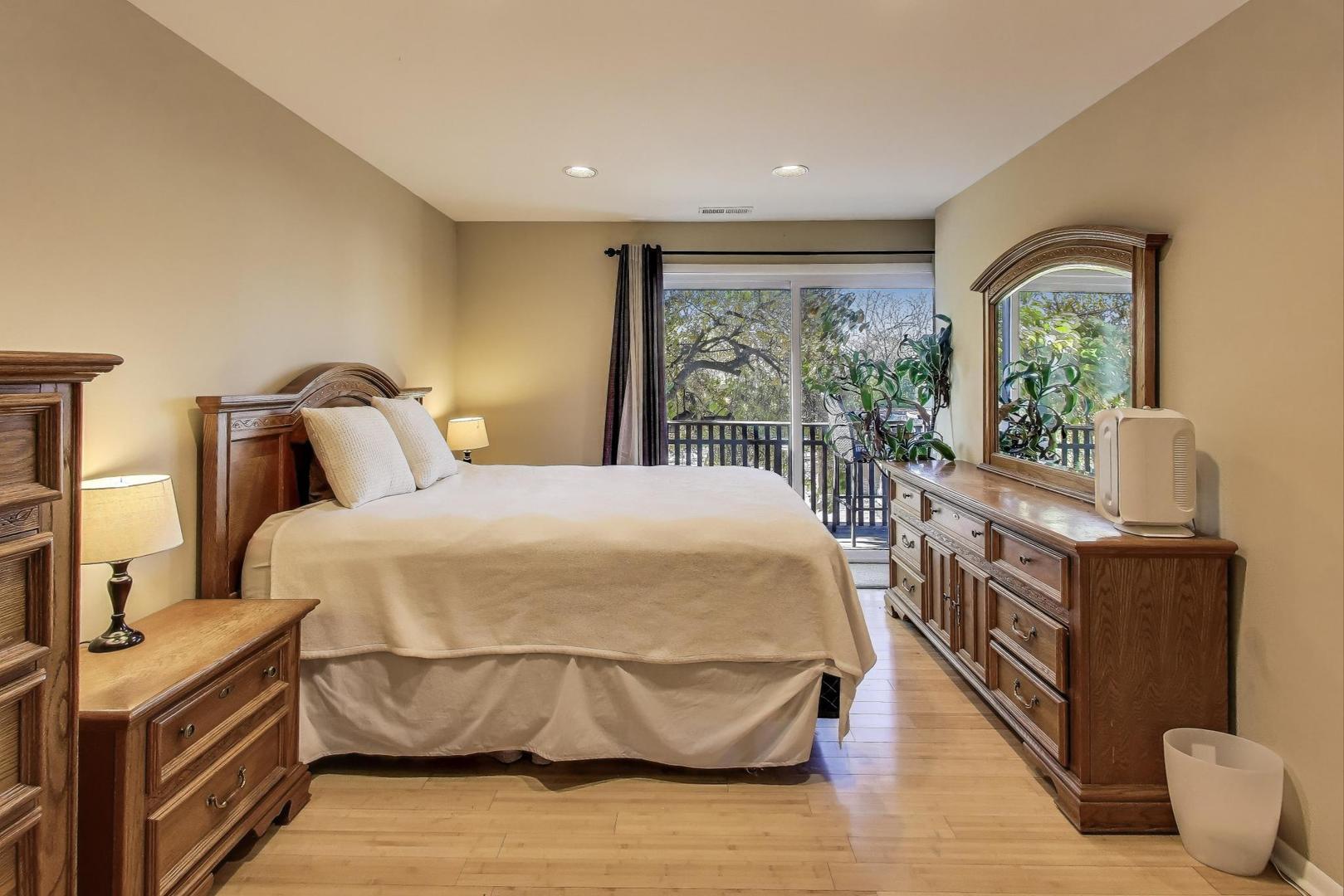 1847 Tanglewood Drive, Unit 2B Glenview, IL 60025 - Photo 10 of 26 a bedroom with a large bed and a flat tv screen on dresser